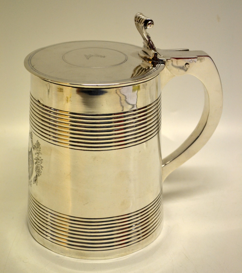 A large silver George III lidded tankard, the tapering body with reeded banding and engraved a