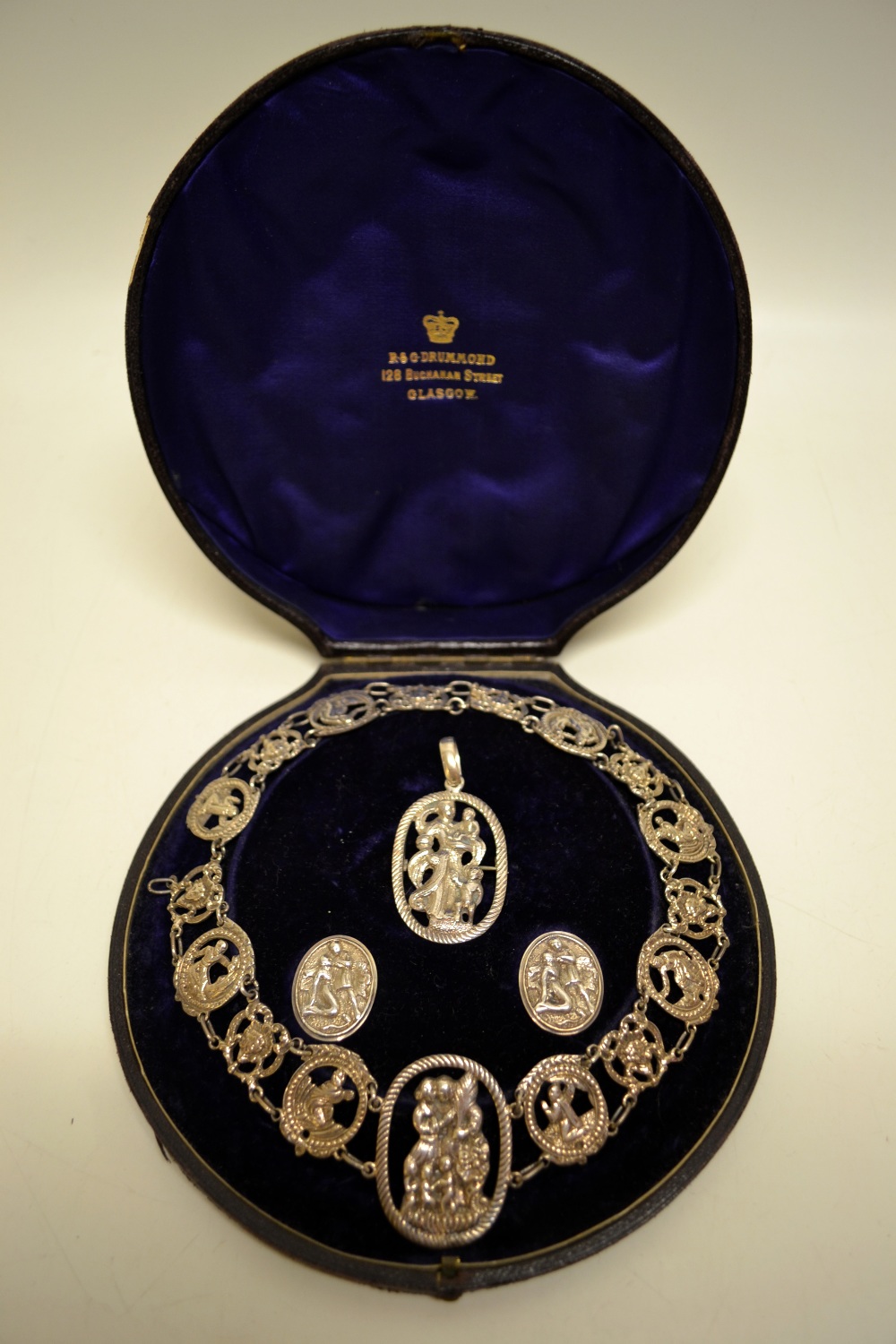 A Victorian silver Dutch style necklace and pendant with cloak buttons, cast and pierced with