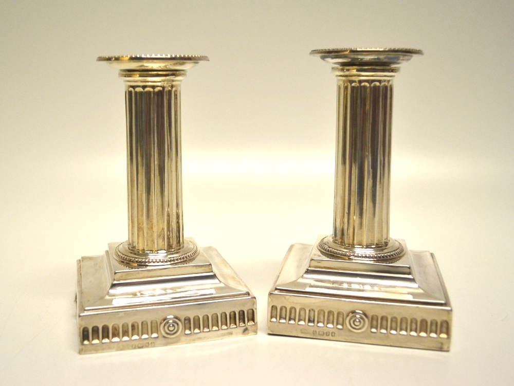 A pair of Victorian silver boudoir candlesticks, the fluted stems with beaded edges and detachable