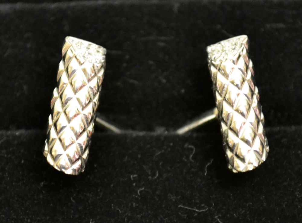 A pair of cuff links white gold coloured metal set diamonds.