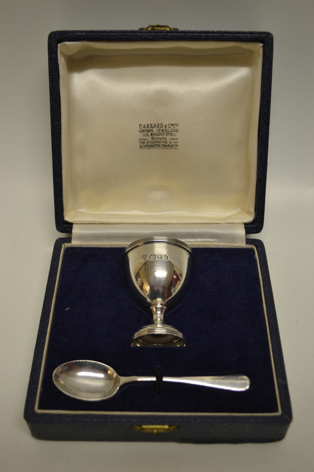 A child`s christening set of silver egg cup and rattail spoon, Makers and retailer Garrard & Co Ltd