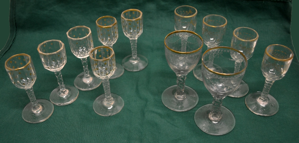 Two late eighteenth century port glasses, the bowls swag cut with beeded borders and gilt rims, on