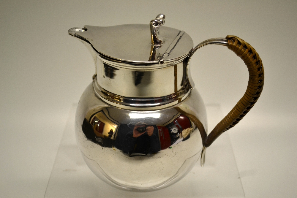 A silver hot water jug, the bulbous body with a hinged cover, an Onslow thumbpiece, a scroll spout