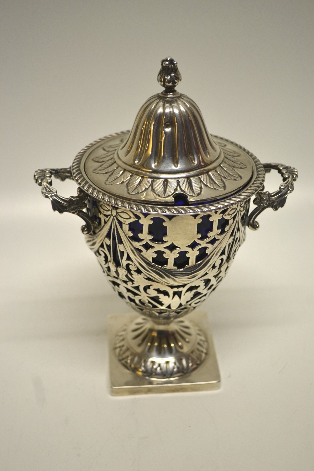 An Edwardian pierced fretwork silver preserve vase, in Adam style, decorated tied swags and