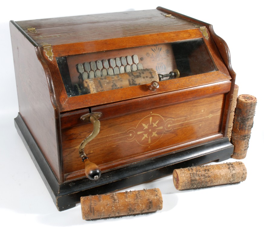 A late 19th c. Oak cased ''Concert Roller Organ'' with gilt detail, brass hinges and pin and