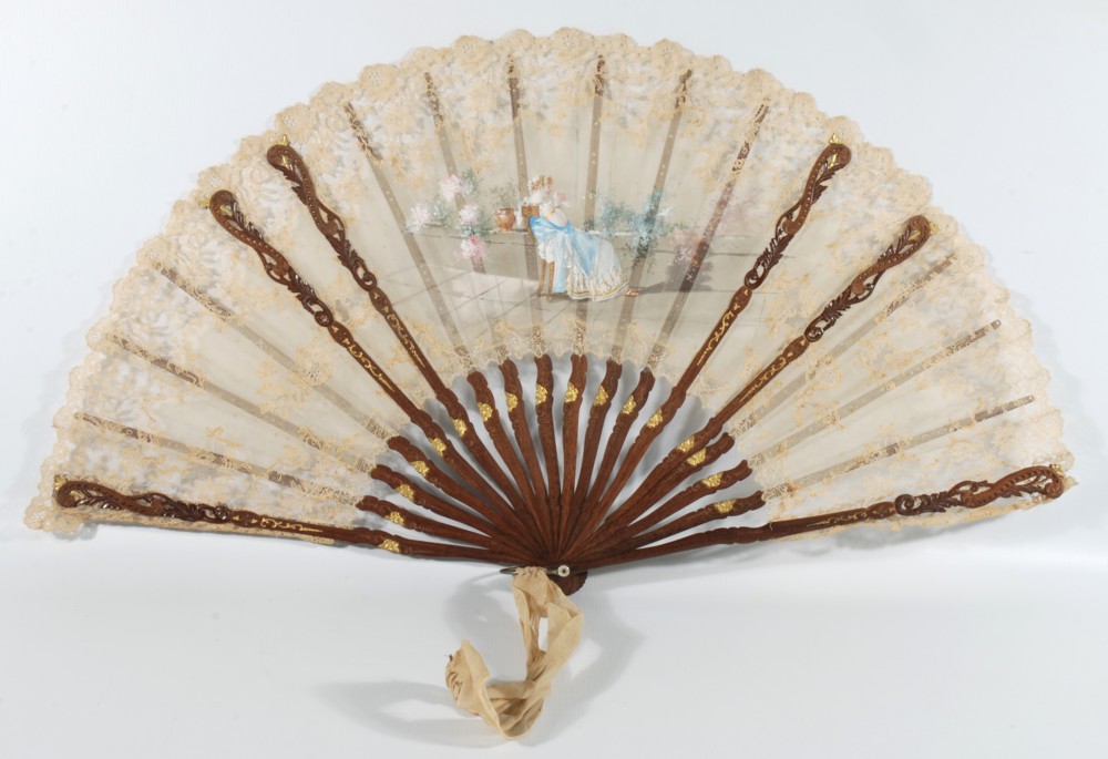 A fine gauze and lace Fan, hand painted with a figure of a seated lady in a garden with white doves,