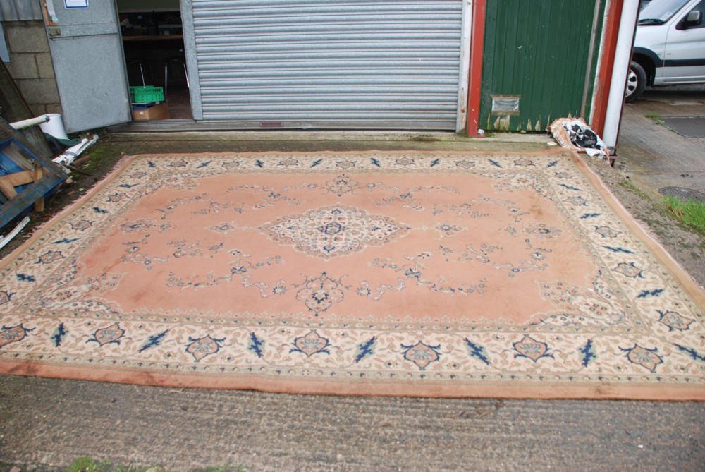 A brown ground Rug with navy and green floral pattern, 108" x 146"