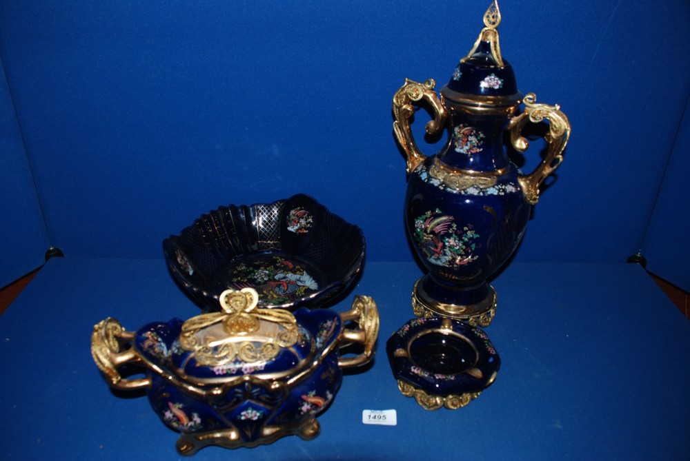 A quantity of dark blue china with oriental bird design and gilt detail, including two bowls, vase