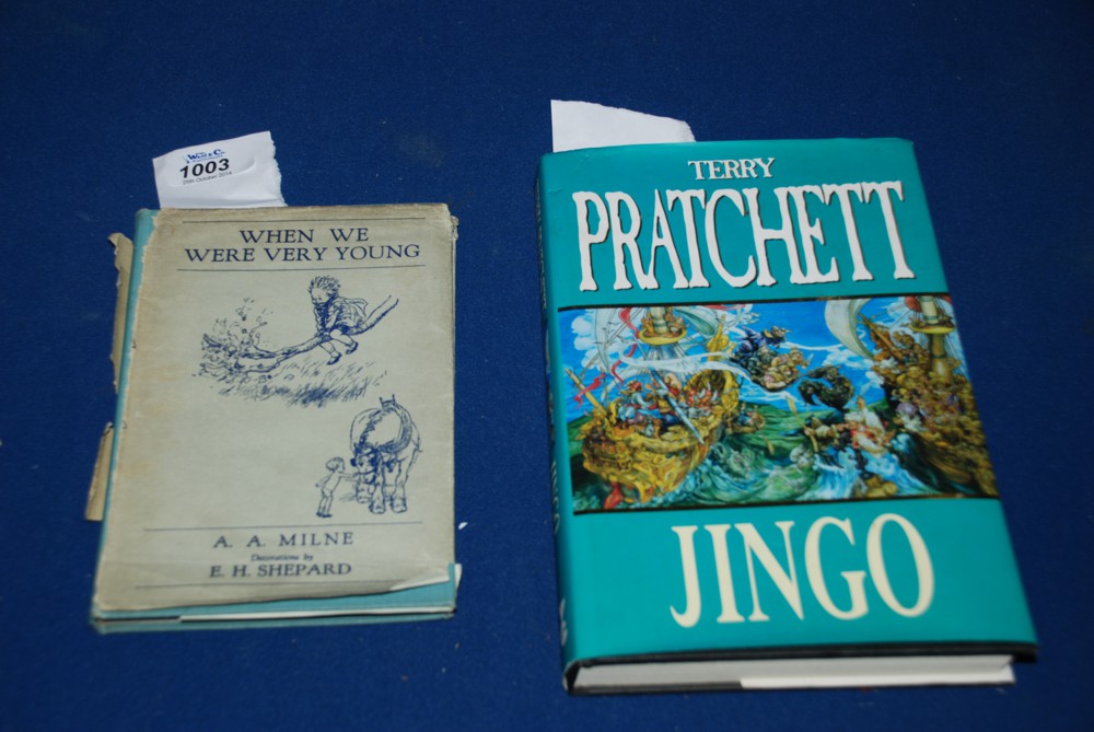 A hardback volume 'When we were very Young' by A.A. Milne and a signed copy of 'Jingo' by Terry