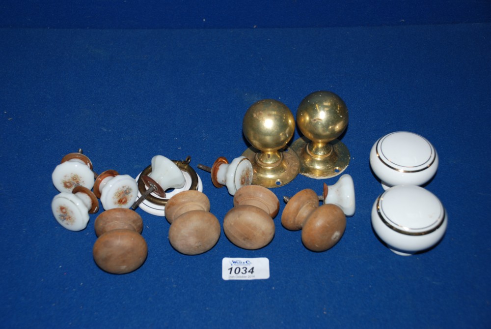 A quantity of Door Knobs to include wood, brass and china etc.