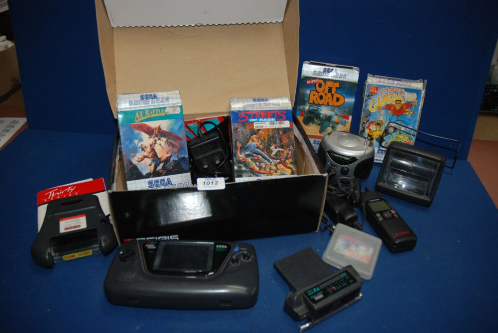 A Sega portable video game system with a game gear T.V. tuner, a game Genie, games etc, along with a