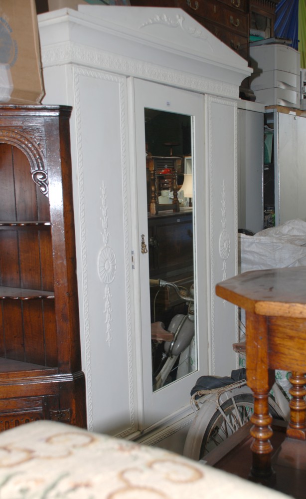 A mid 19th c. painted Pine shabby chic style single door Wardrobe having carved pediment top over
