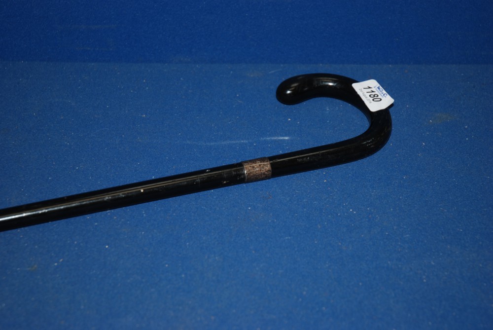 An Ebonised Walking Cane with silver collar.