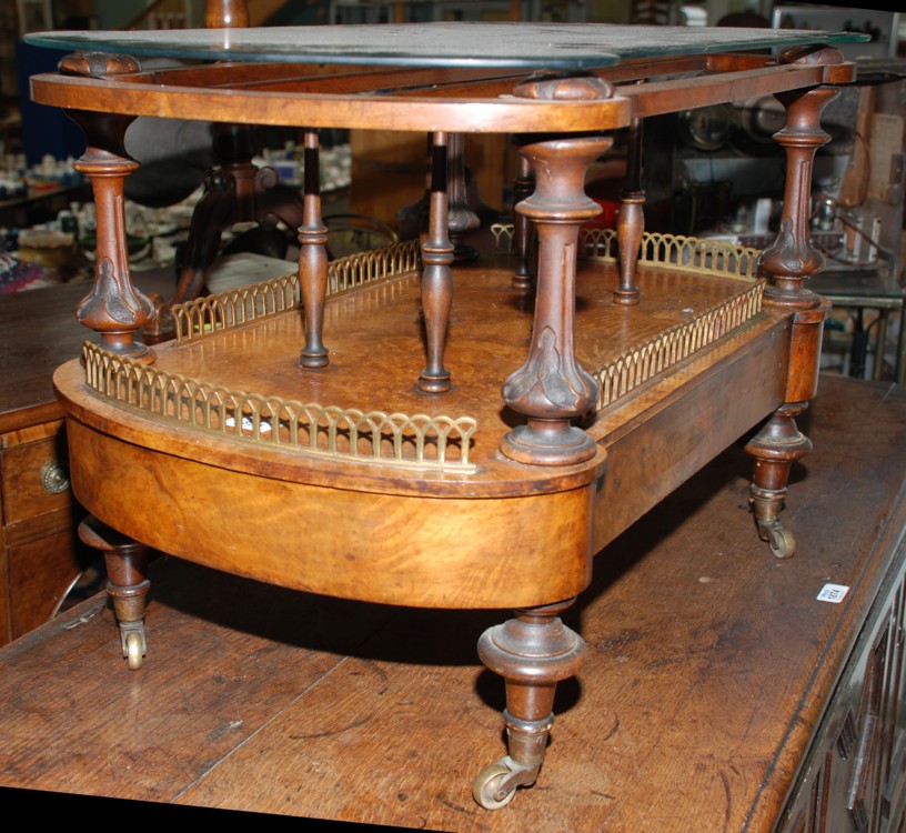 An early 19th c. Walnut Canterbury 'I' shaped slatted top on carved turned and fluted supports,
