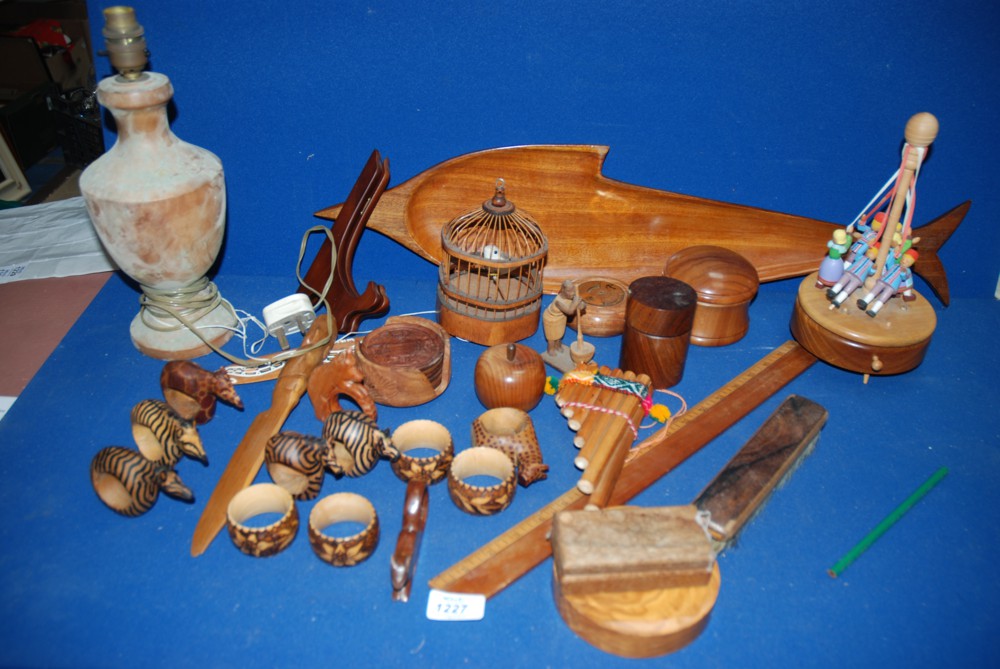 A large quantity of treen including animal serviette rings, fish serving dish, wooden ruler, treen