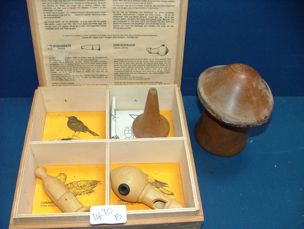 A wooden box containing four Bird calling Whistles, made in Germany