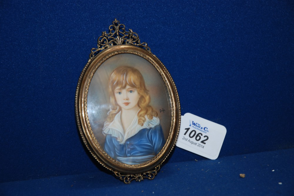 An oval Portrait Miniature of a Girl in a Blue dress with lace collar, signed Gada, probably on