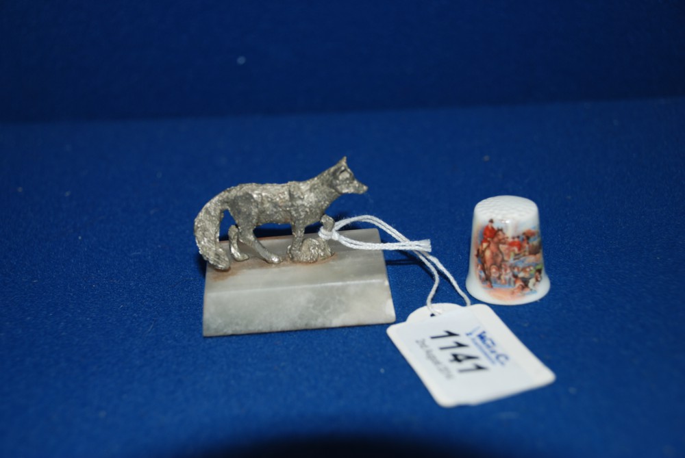 A  Silver Coloured Onyx Mounted Fox Paperweight Together with a Ceramic Hunting Scene Thimble.