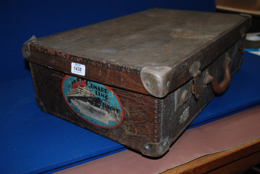 A wooden Suitcase with metal beaded edging, leather corners, with label marked ''Cunard Line to