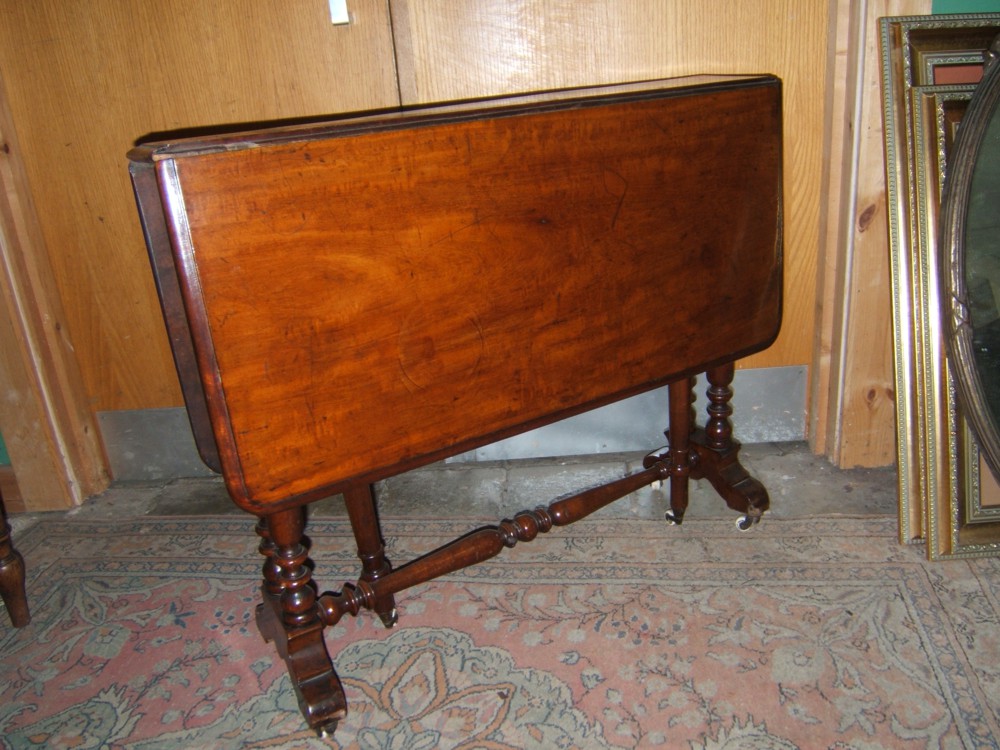 A Victorian Walnut Sutherland Table having narrow top with long leaves and moulded edge, on turned