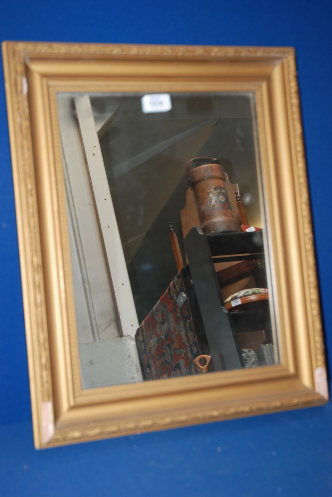 An ornate gilt coloured framed Mirror, some damage to frame.  12'' x 16 1/4''