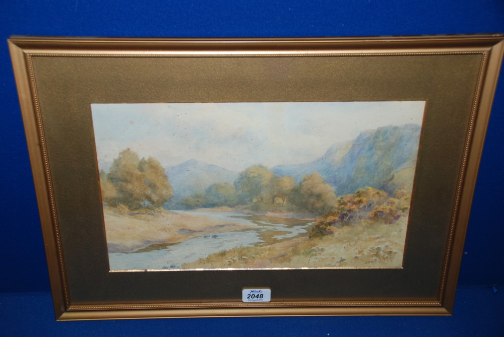 A Watercolour of a River landscape with trees and mountains in the distance, signed lower left L.