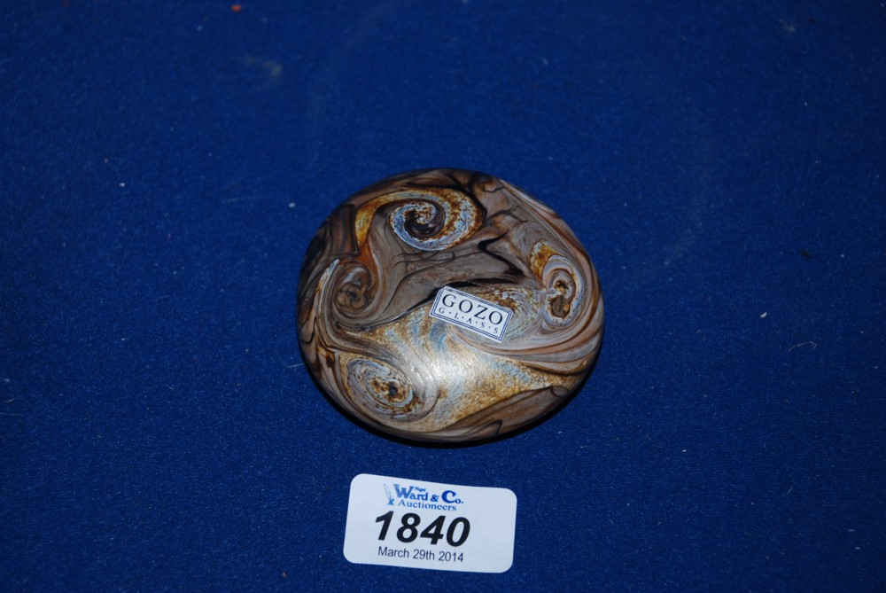 A Gozo glass Paperweight in brown swirl effect.