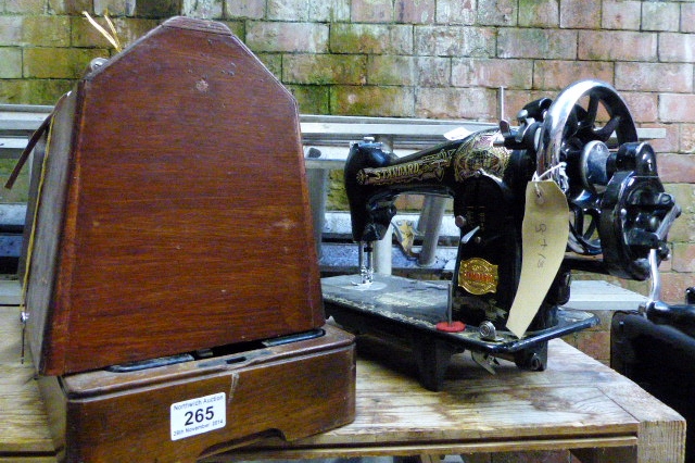 Two vintage hand powered sewing machines including a Standard American model