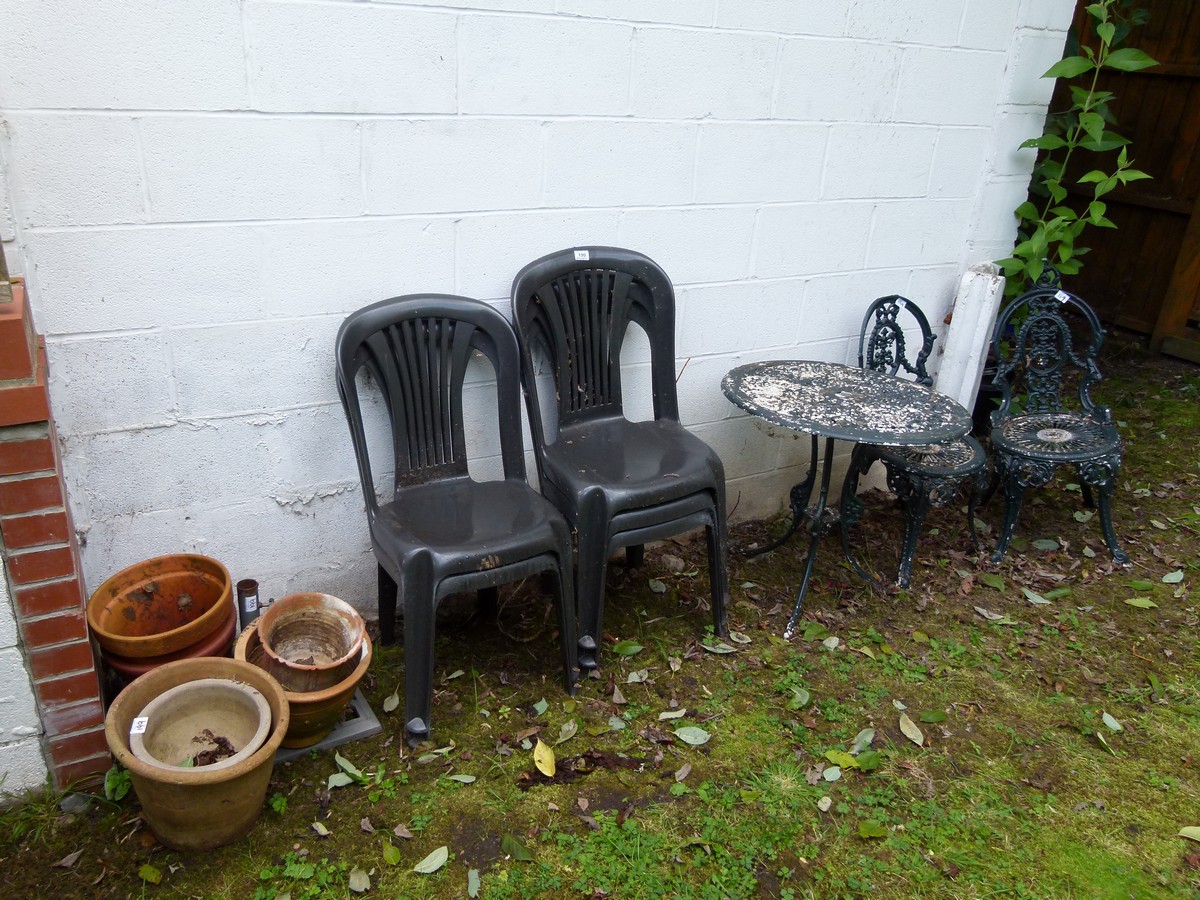 Cast metal garden table and two chairs etc