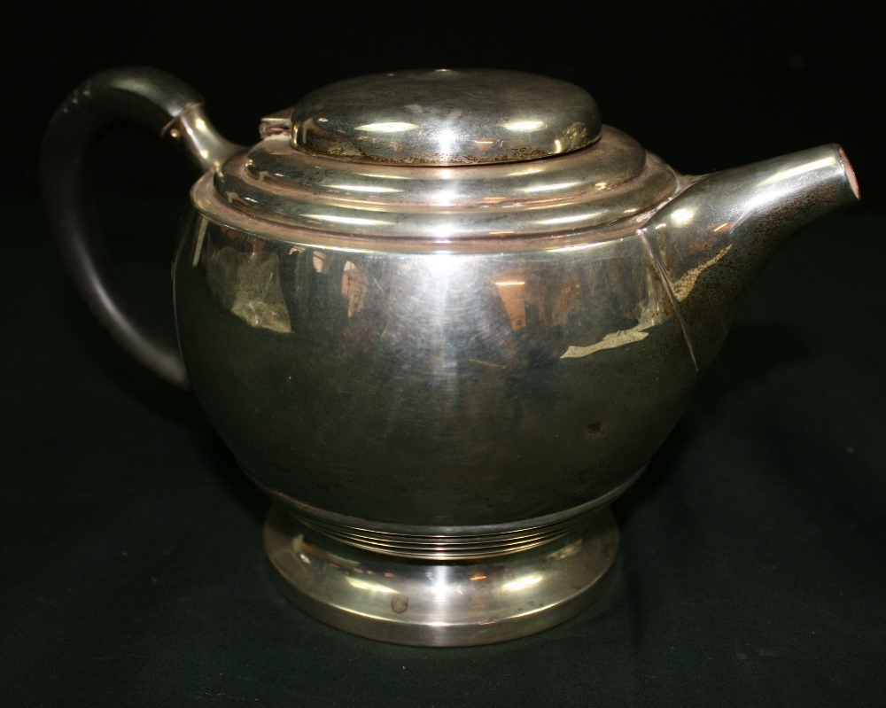 WALKER AND HALL - A sterling silver teapot by Walker and Hall, with ebony handle. Teapot is