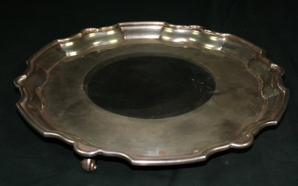 FINNIGANS LTD - A solid silver salver by Finnigans Ltd. Salver is raised on 3 decorative feet with