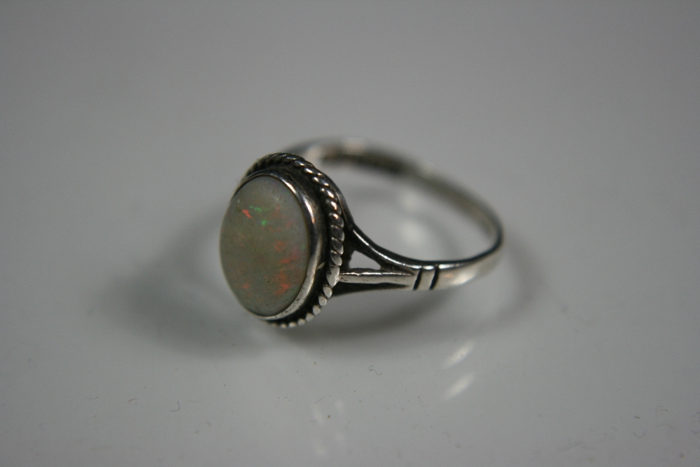 OPAL RING - A silver and opal ring with hallmarks for Birmingham 1954. Ring comes in vintage box.