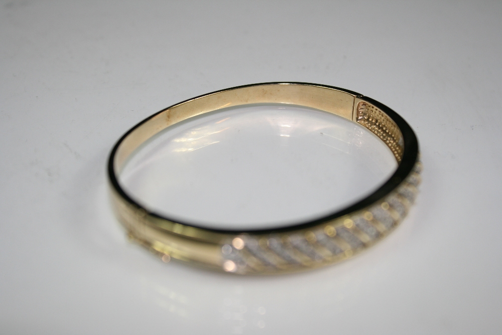 GOLD / DIAMOND BANGLE - A 9ct gold and diamond bangle in Mount Royal box. Total weight16.7g. - Image 2 of 3