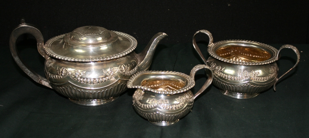 JAMES DEAKIN AND SONS - A decorative silver teapot, sugar bowl and milk jug by James Deakin and