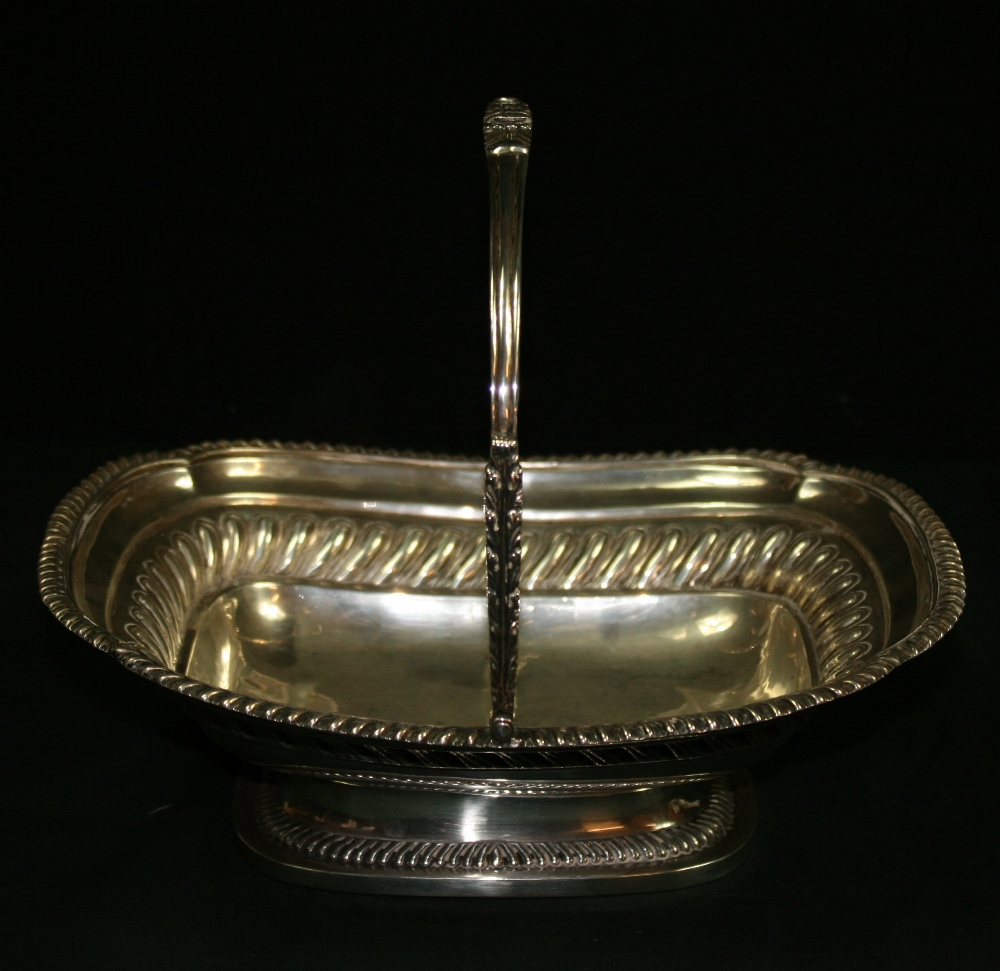 CHARLES STUART HARRIS -  A decorative cake basket with rope boarder around the edge and decorative