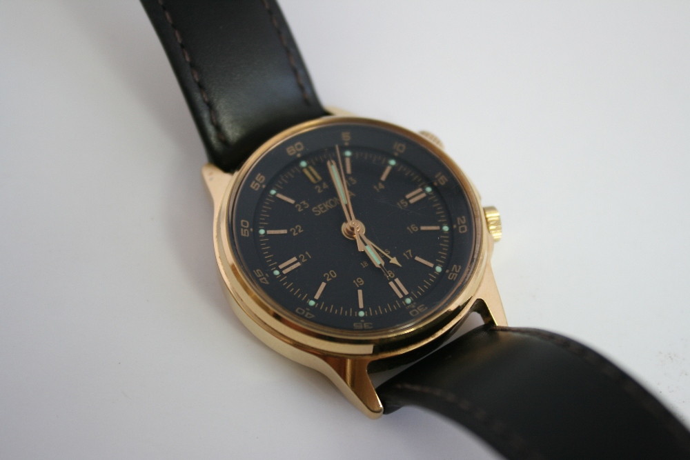 SEKONDA -  A vintage Sekonda gold plated alarm watch in the military style with a black dial. The