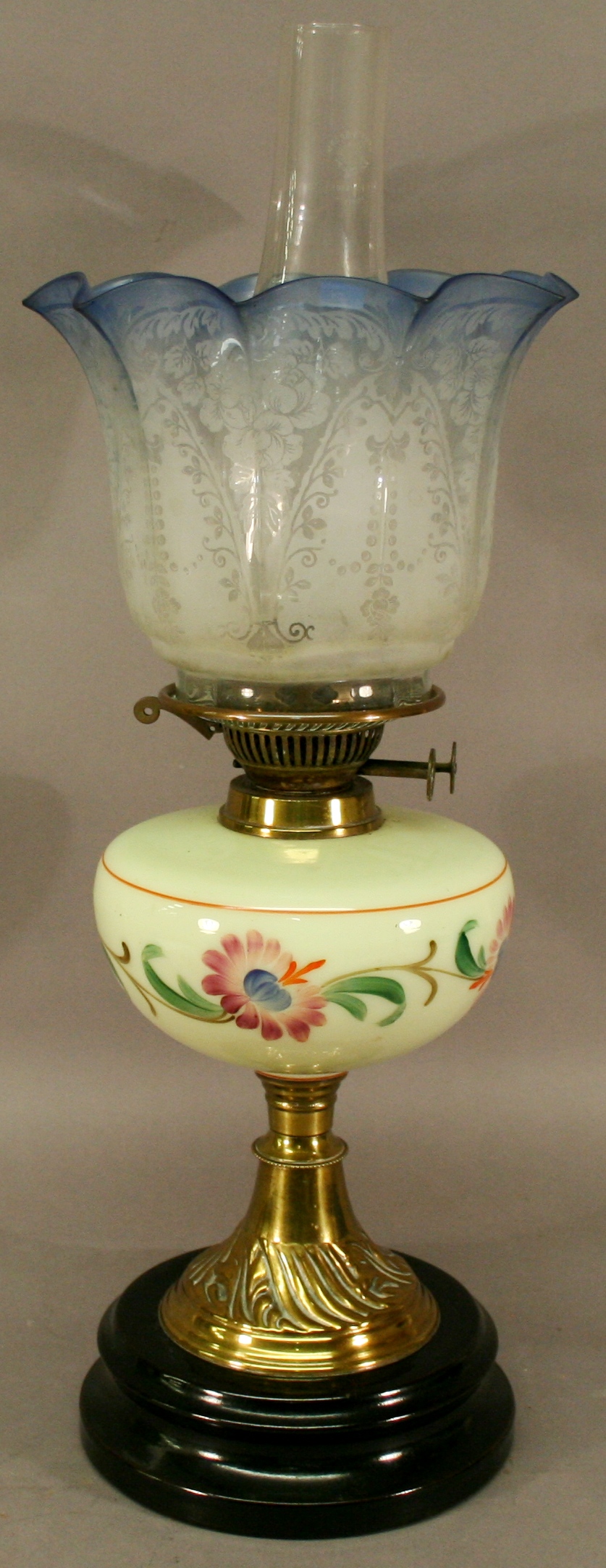 A VICTORIAN BRASS AND GLASS OIL LAMP having a flared fluted glass shade with acid-etched decoration