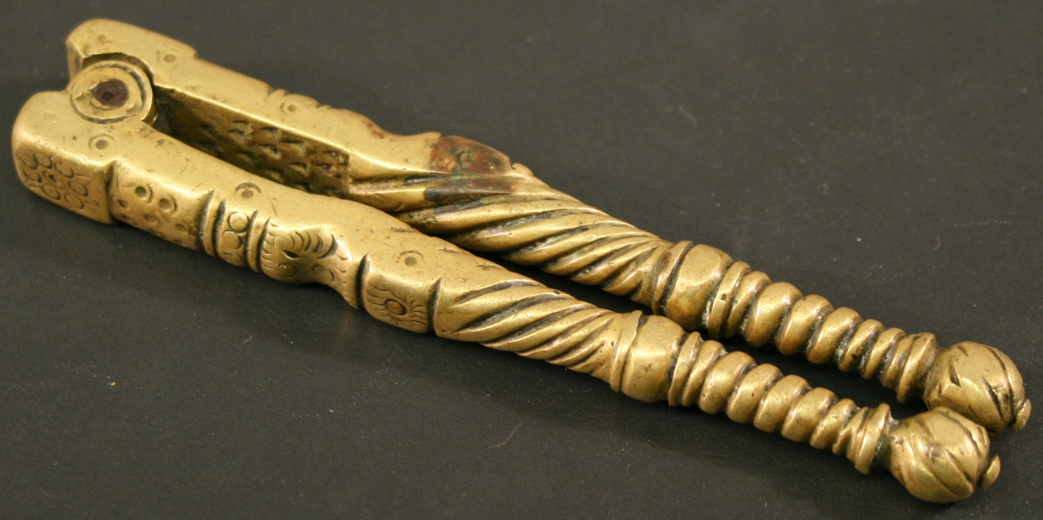 A PAIR OF 18TH CENTURY BRASS NUT CRACKERS c1770, with twisted and punched decoration.  10cm(L)