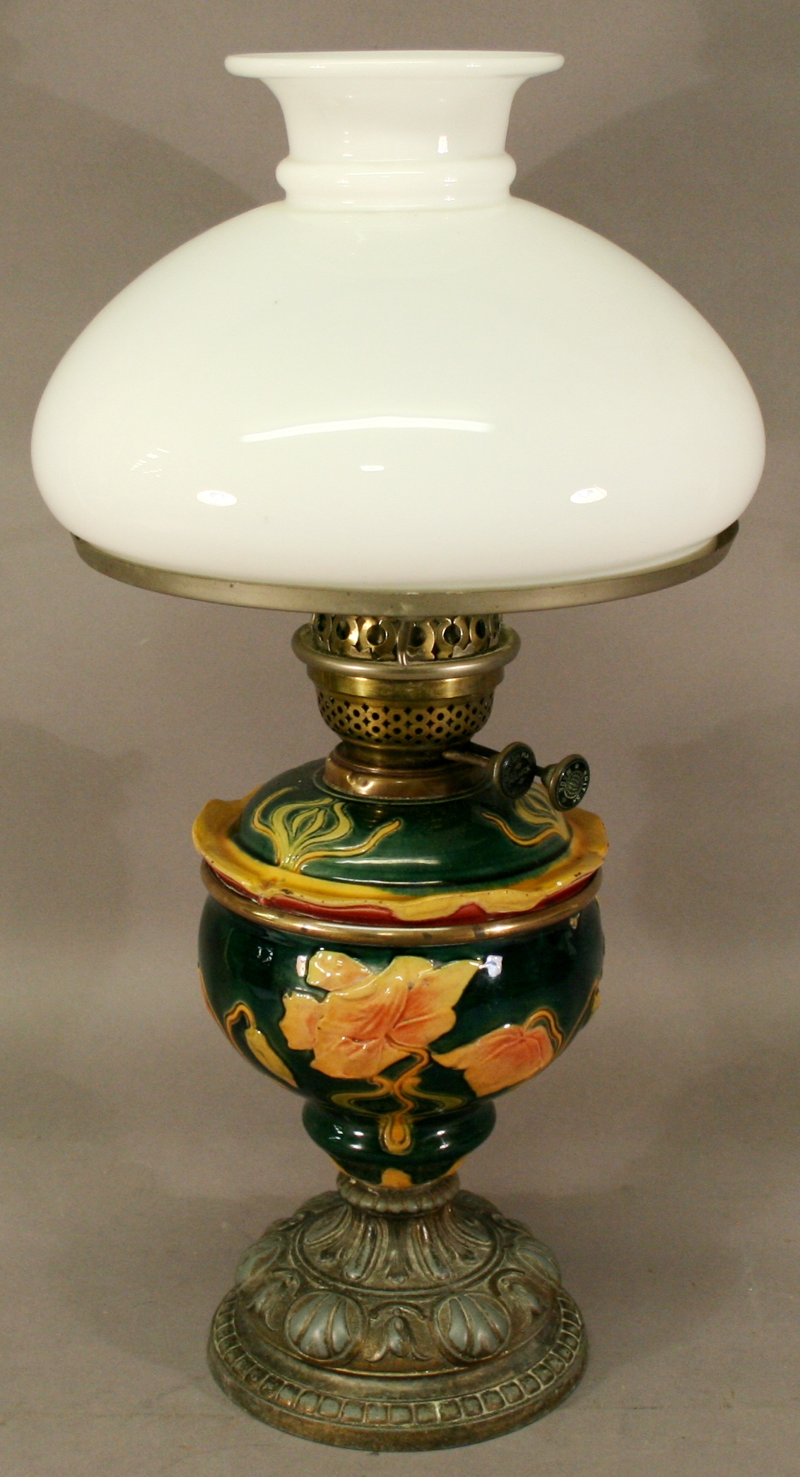 A VICTORIAN POTTERY CAST BASE OIL LAMP having a domed opaque glass shade with short everted central