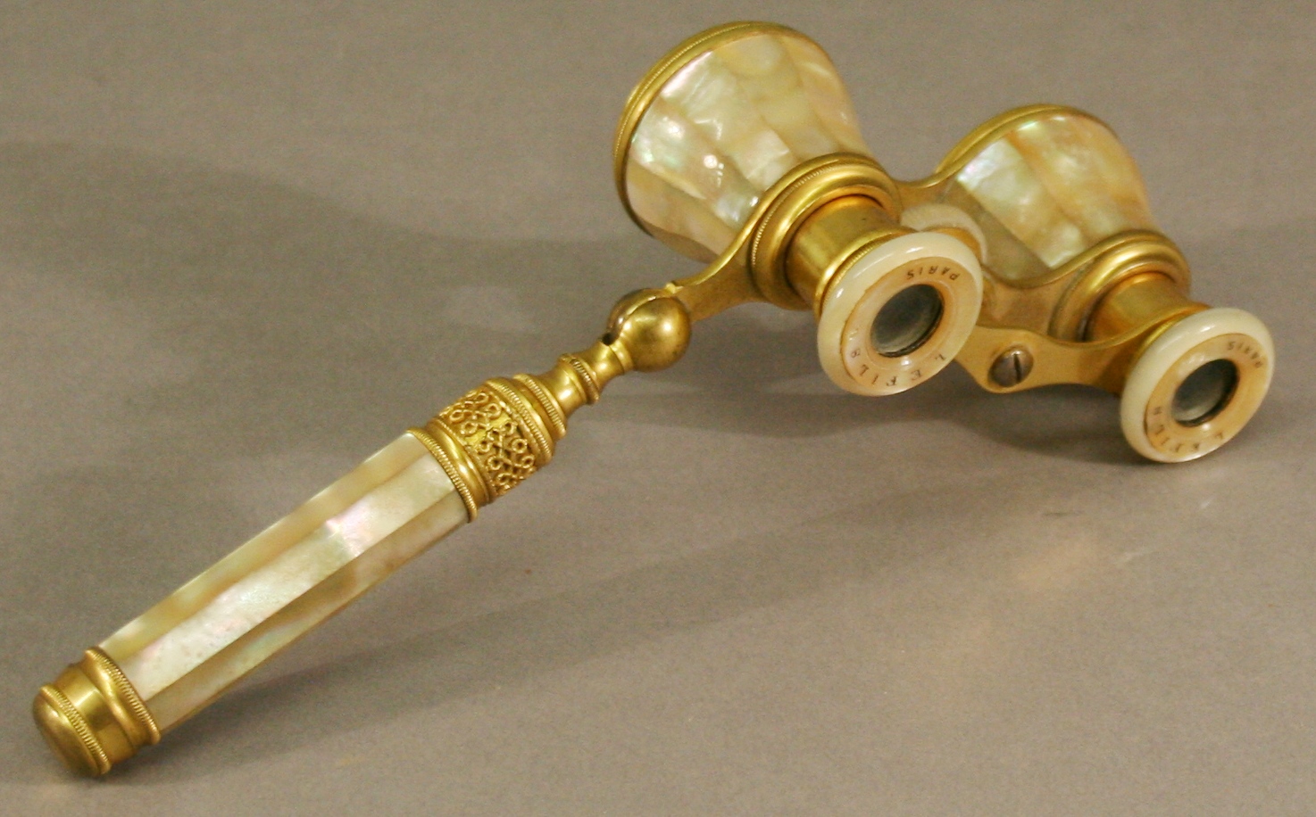 A PAIR OF FRENCH GILT-METAL AND MOTHER-OF-PEARL OPERA GLASSES by Lefils, Paris, of typical form