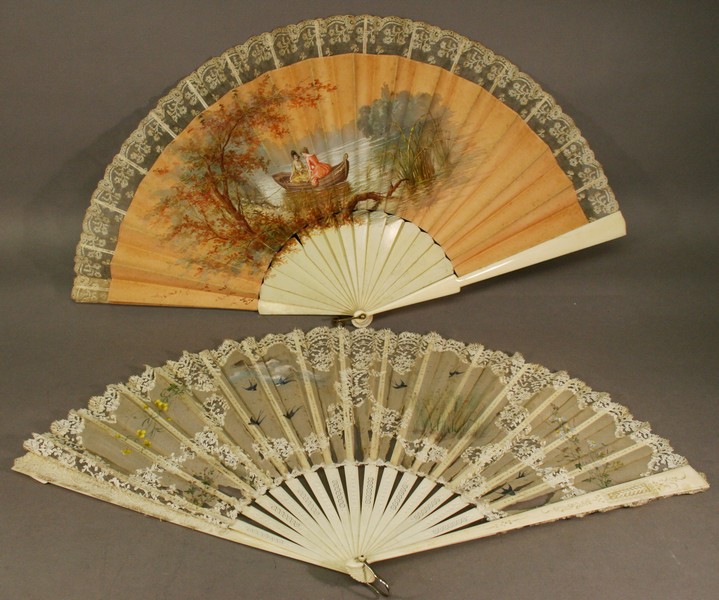 TWO 19TH CENTURY IVORY FANS, the first with plain tapering guards and sticks, the silk lace topped