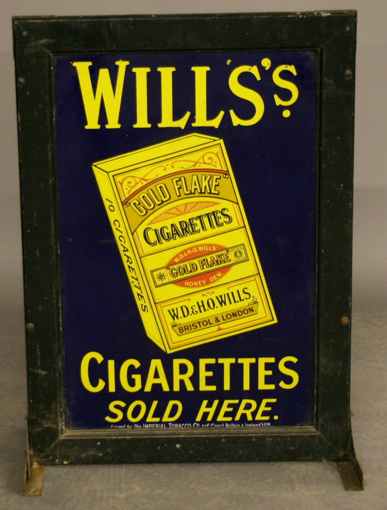 A WILLS`S `GOLD FLAKE` CIGARETTES ENAMEL ADVERTISING SIGN c1920, rectangular, held in a wood and