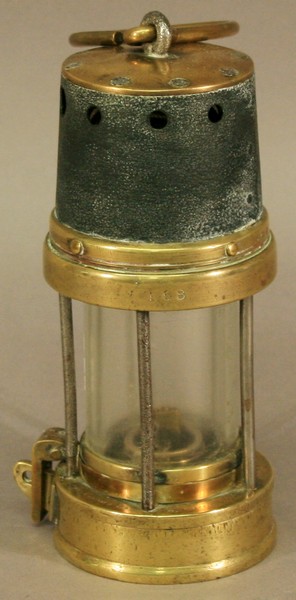 A BRASS AND IRON MINERS LAMP typical form struck twice with number 168.  20cm  Used condition with