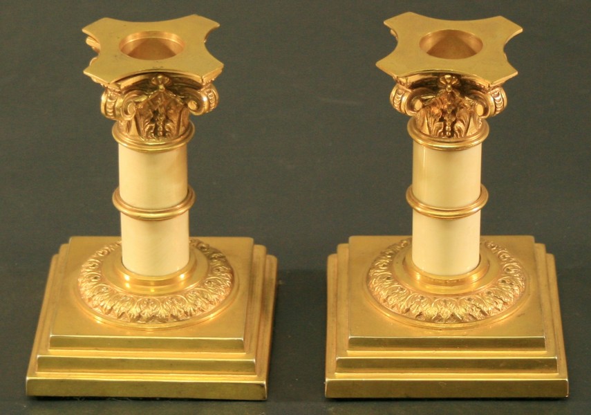 A PAIR OF GILT METAL AND IVORY COLUMN CANDLESTICKS late 19th century, of classical design with