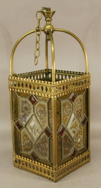 A LATE VICTORIAN BRASS AND STAINED GLASS HALL LANTERN of square section form with stained and