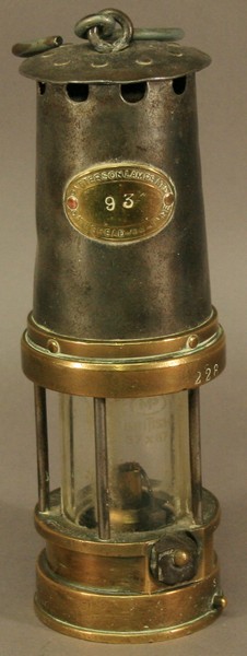 A PATTERSON LAMPS LTD (GATESHEAD-ON-TYNE) TYPE A.1 MINERS LAMP of typical form in brass and iron