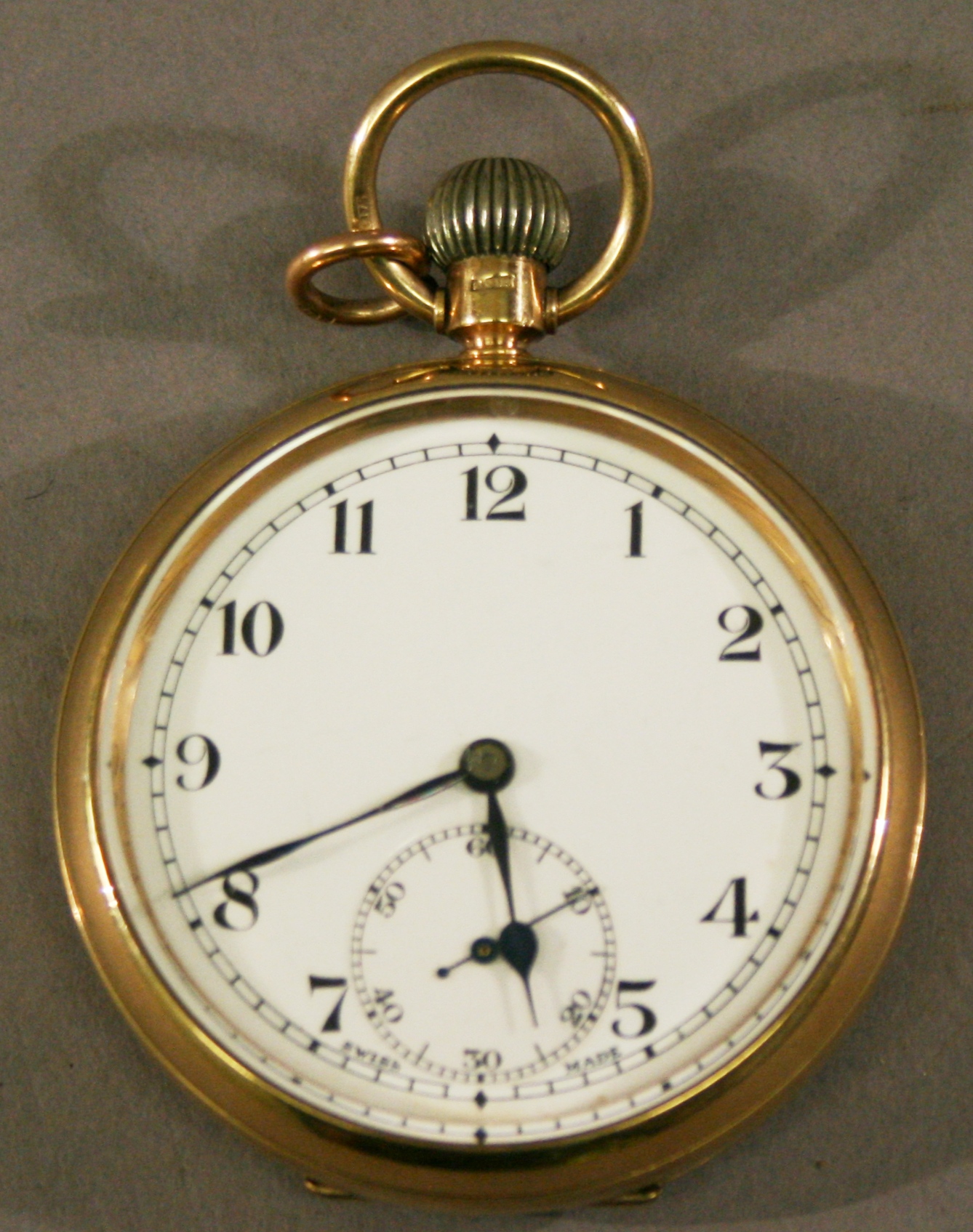 A 9CT GOLD CASED OPEN-FACED POCKET WATCH of typical form, with Arabic hours framing a subsidiary