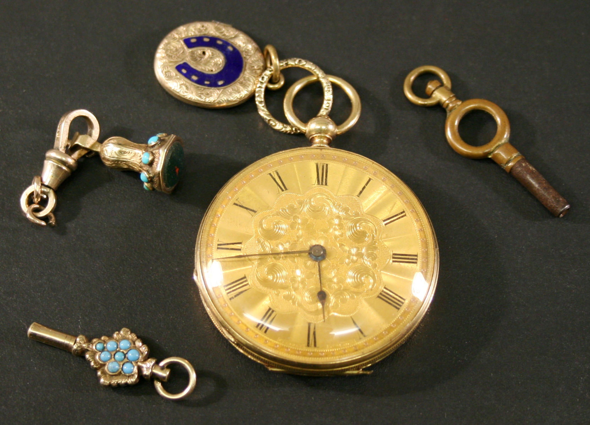 A YELLOW METAL CASED OPEN-FACED POCKET WATCH with Roman hours to the foliate decorated gold tone
