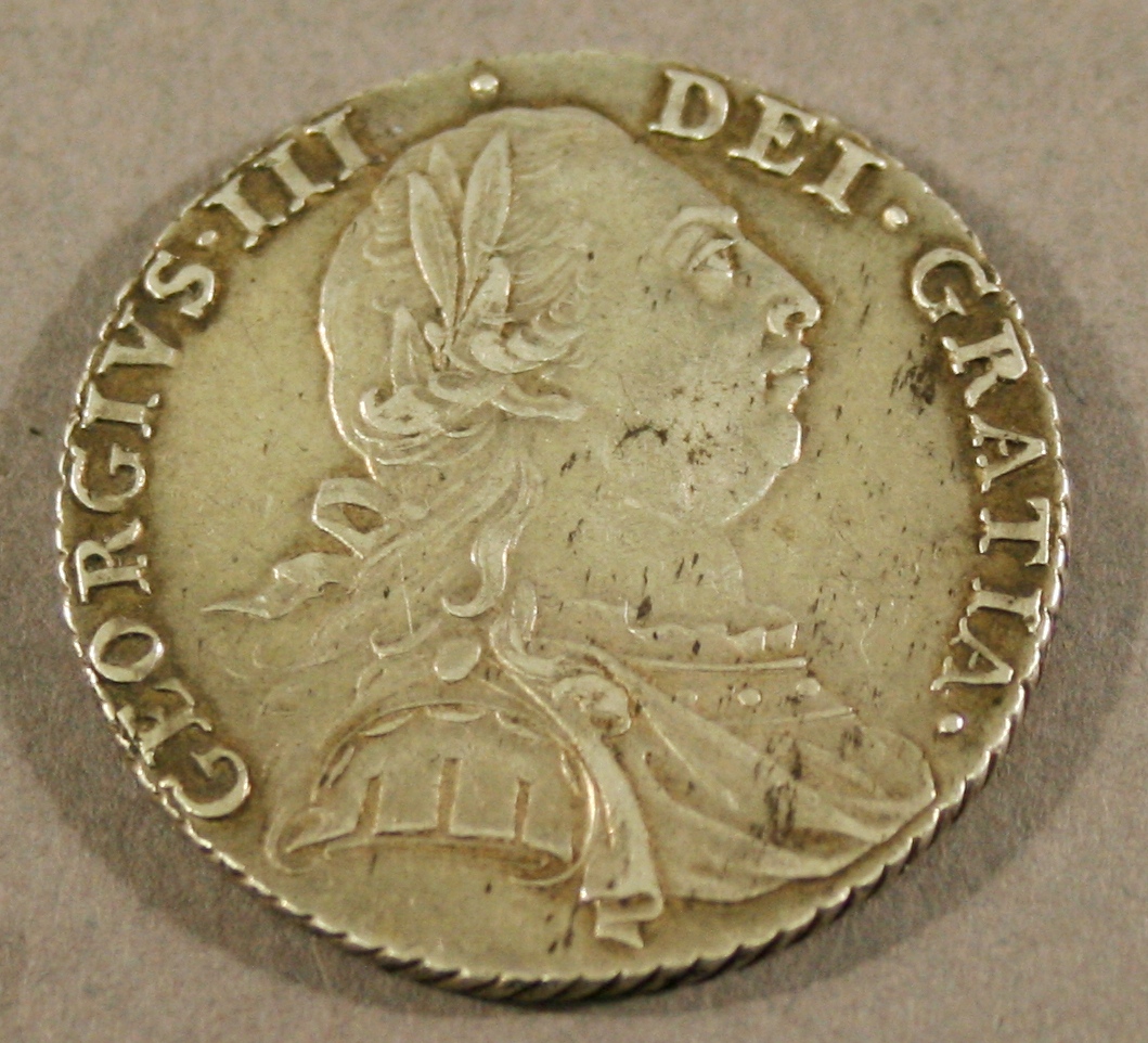 A GEORGE III SHILLING 1787 laureate, draped and cuirassed bust right, with semé of hearts. 2.5cm(d)