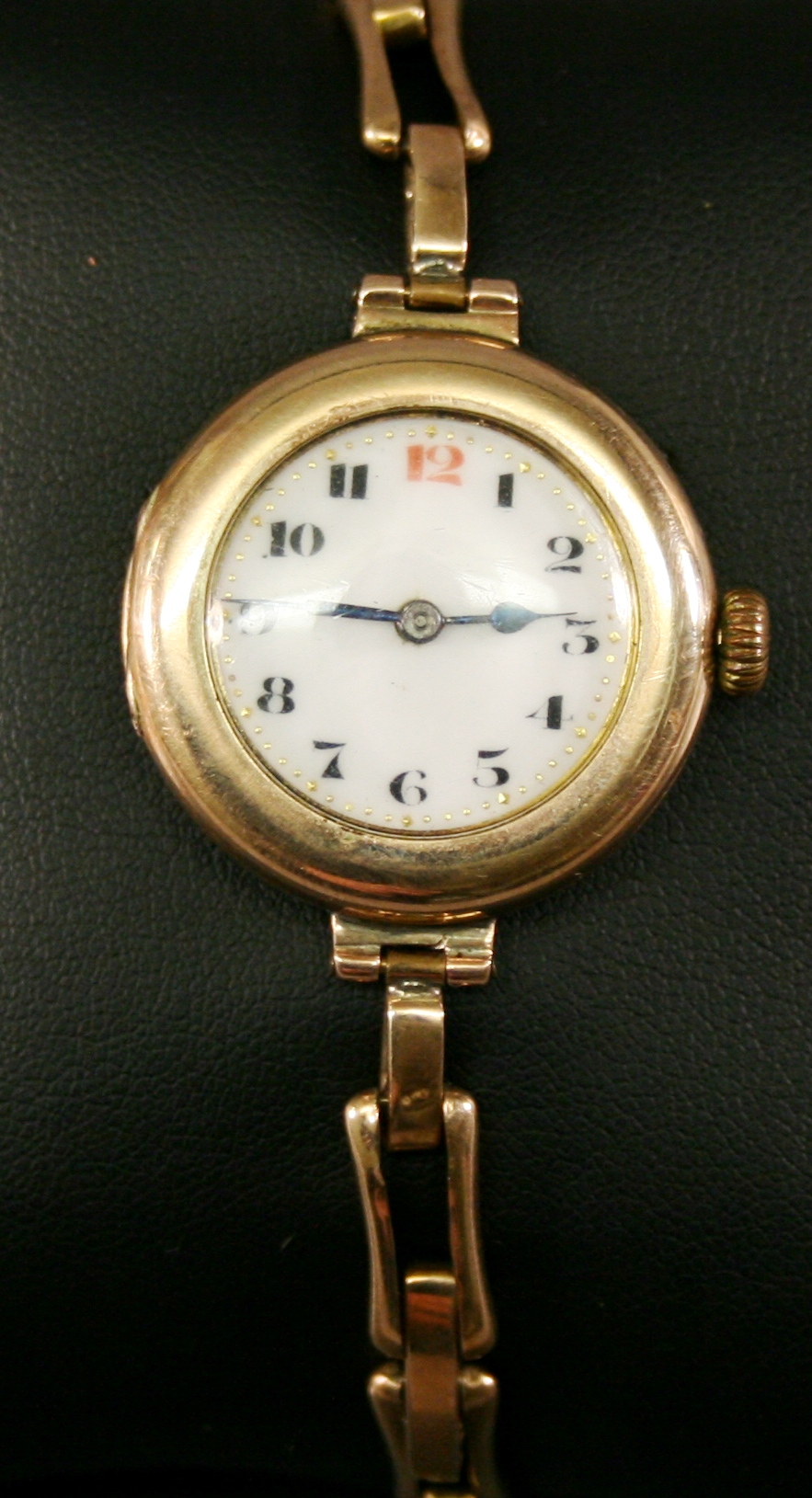 A 9CT GOLD CASED WRISTWATCH of circular form with Arabic hours to the white enamel dial, marked 375